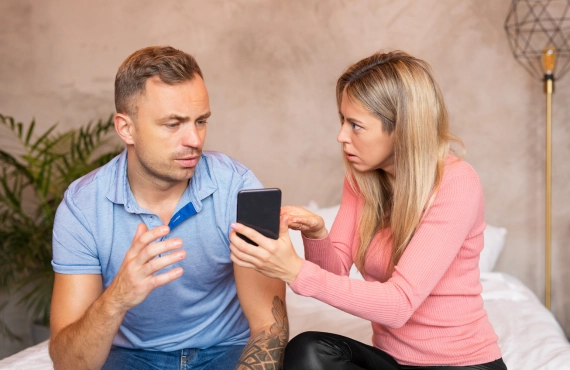 Woman Asking Man to Explain What's on the Phone