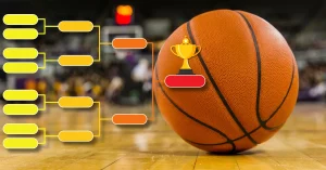 basketball on basketball court with march madness bracket and trophy