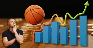 basketball on top of coins on table with 3d bar graph with trend line and man looking up thinking