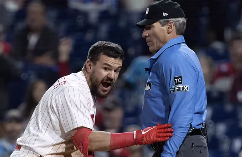 A heated confrontation over a strike call during an MLB game, emblematic of the frustrations with human umpire inconsistencies.