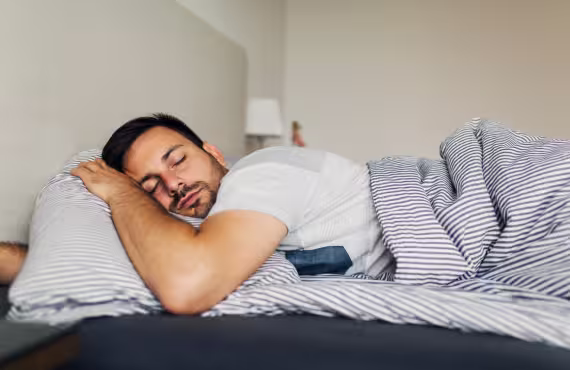 Tired Man Sleeping Peacefully in His Bed