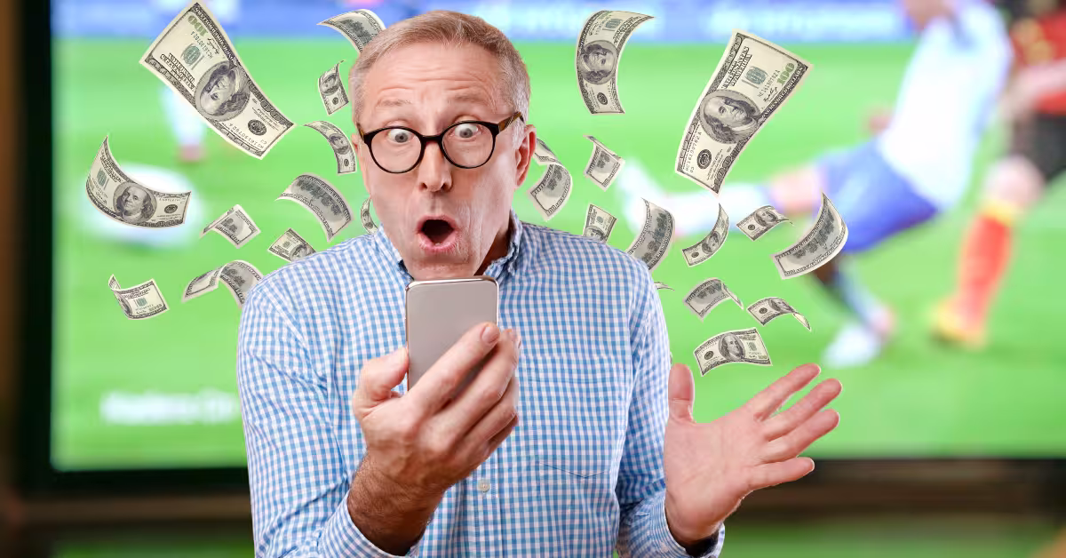 Excited Mature Man Using Mobile Phone and Celebrating Exploit Arbitrage Opportunities - Watching a Soccer Match