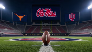 Ole Miss logo on a stadium video board beside Texas Longhorns and Indiana logos, with a football on a tee at midfield